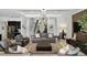 Inviting living room with modern lighting, neutral tones, and seamless flow to dining area at 2118 Whiting Trl, Orlando, FL 32820