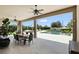 Covered patio with ceiling fans and dining table overlooking the pool and backyard at 2118 Whiting Trl, Orlando, FL 32820