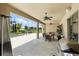 Covered patio with ceiling fans, outdoor kitchen, and views of the pool and backyard at 2118 Whiting Trl, Orlando, FL 32820