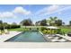 Stunning backyard features a modern pool, lounge chairs and meticulously maintained landscaping at 2118 Whiting Trl, Orlando, FL 32820