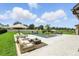 Relaxing backyard with a pool, modern lounge seating and lush green lawn and manicured hedges at 2118 Whiting Trl, Orlando, FL 32820