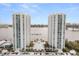 Stunning aerial view of waterfront condos with a pool and water views on a bright, sunny day at 241 Riverside Dr # 902, Holly Hill, FL 32117