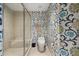 Bathroom featuring a toilet, glass shower and patterned wall coverings at 241 Riverside Dr # 902, Holly Hill, FL 32117