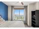 Bedroom view showing a large window with water and city views at 241 Riverside Dr # 902, Holly Hill, FL 32117