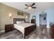 Bedroom featuring hardwood floors, ceiling fan, accent wall, and a large window at 241 Riverside Dr # 902, Holly Hill, FL 32117