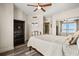 Bright bedroom featuring a ceiling fan, closet, and stylish decor at 241 Riverside Dr # 902, Holly Hill, FL 32117