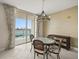 Dining area with a chandelier and balcony access offering city and water views at 241 Riverside Dr # 902, Holly Hill, FL 32117