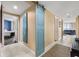 Hallway with access to the bedroom and living area, featuring a stylish barn door accent and modern design elements at 241 Riverside Dr # 902, Holly Hill, FL 32117