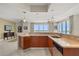 Modern kitchen with a countertop bar, updated stainless steel appliances, and scenic views from the window at 241 Riverside Dr # 902, Holly Hill, FL 32117