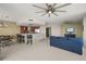 Open living space with a modern kitchen, a dining area, and comfortable seating with large ceiling fans at 241 Riverside Dr # 902, Holly Hill, FL 32117
