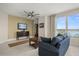 Living room with a flat screen TV, area rug, and gorgeous water views at 241 Riverside Dr # 902, Holly Hill, FL 32117