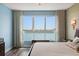 Bright bedroom showcasing water views, hardwood floors, and elegant decor at 241 Riverside Dr # 902, Holly Hill, FL 32117