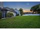 Spacious backyard with lush green grass and partial view of the home at 2523 Madron Ct, Orlando, FL 32806