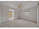 Bright bedroom with a ceiling fan, neutral walls, carpeted floors, and two windows with wooden blinds at 2523 Madron Ct, Orlando, FL 32806