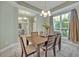 Bright dining room with large window, neutral tones, and view of the outdoors at 2523 Madron Ct, Orlando, FL 32806