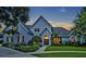 Charming two-story home with beautifully landscaped yard and inviting entrance at dusk at 2523 Madron Ct, Orlando, FL 32806