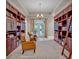 Stunning library with floor-to-ceiling bookcases, seating, and an elegant chandelier at 2523 Madron Ct, Orlando, FL 32806
