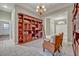 Elegant library with large wooden bookcase, ladder, and cozy seating area at 2523 Madron Ct, Orlando, FL 32806