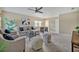 Relaxing living room with a sectional sofa, two armchairs, comfy poufs, foosball table, and bright windows at 2523 Madron Ct, Orlando, FL 32806