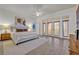 Spacious bedroom boasts tile floors, king bed, ceiling fan, and access to a private balcony through glass doors at 2523 Madron Ct, Orlando, FL 32806