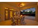 Inviting outdoor patio with dining set, ceiling fan, and views of the pool and backyard at 2523 Madron Ct, Orlando, FL 32806