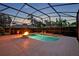 Screened swimming pool with a built-in fire pit for outdoor enjoyment at 2523 Madron Ct, Orlando, FL 32806