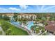 A sprawling complex with a community pool and waterslide, nestled amongst lush greenery and well-maintained landscaping at 2531 Maneshaw Ln, Kissimmee, FL 34747