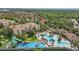 An expansive aerial view of the community pool and recreational area with mature trees and landscaping at 2531 Maneshaw Ln, Kissimmee, FL 34747