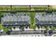 Aerial view showcasing townhouses, patios with pools, and manicured grounds at 2531 Maneshaw Ln, Kissimmee, FL 34747