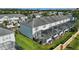 Aerial view of townhouse backyards featuring screened patios and private pools at 2531 Maneshaw Ln, Kissimmee, FL 34747