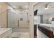 Modern bathroom with glass-enclosed shower and a view into the bedroom at 2531 Maneshaw Ln, Kissimmee, FL 34747