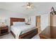 Well-lit bedroom showcasing a large bed with storage drawers and hardwood furniture at 2531 Maneshaw Ln, Kissimmee, FL 34747