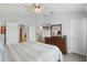 Bedroom with a bed, dresser, and bathroom entrance at 2531 Maneshaw Ln, Kissimmee, FL 34747