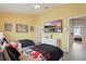 Bedroom with two beds, bright yellow walls, and a television at 2531 Maneshaw Ln, Kissimmee, FL 34747
