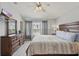 Spacious bedroom with a large bed, dresser, and view of the building across the street at 2531 Maneshaw Ln, Kissimmee, FL 34747