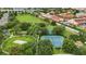 Aerial view of community amenities including tennis courts, a sand volleyball court, and green space at 2531 Maneshaw Ln, Kissimmee, FL 34747
