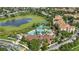 Aerial view of a community pool, water slide, and complex next to a lake at 2531 Maneshaw Ln, Kissimmee, FL 34747