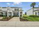 Well-maintained townhouse with landscaping, driveway, and covered entryway at 2531 Maneshaw Ln, Kissimmee, FL 34747