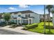 Light blue two-story townhome with a well-manicured lawn and garden at 2531 Maneshaw Ln, Kissimmee, FL 34747