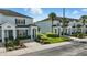 Charming light blue townhouses with manicured front lawns and sidewalks at 2531 Maneshaw Ln, Kissimmee, FL 34747