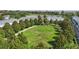 Aerial view of green space with a central walkway and a gazebo in a community at 2531 Maneshaw Ln, Kissimmee, FL 34747
