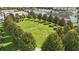 Aerial view of community green space featuring walking path and trees at 2531 Maneshaw Ln, Kissimmee, FL 34747