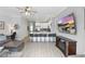 Bright open-concept living area featuring a kitchen with barstool seating and a spacious layout perfect for entertaining at 2531 Maneshaw Ln, Kissimmee, FL 34747