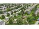 Aerial view of a well-maintained neighborhood with lush landscaping, a park, and a playground at 2531 Maneshaw Ln, Kissimmee, FL 34747
