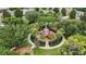 Aerial view of a neighborhood playground featuring a castle-themed play structure, surrounded by lush landscaping at 2531 Maneshaw Ln, Kissimmee, FL 34747