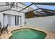 A cozy plunge pool, complete with a brick paved patio, and screened enclosure with white trim at 2531 Maneshaw Ln, Kissimmee, FL 34747