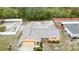 Aerial view of a yellow home with a gray roof, landscaped yard, and a fenced-in backyard at 2741 Beaver Dr, Deltona, FL 32725