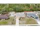 Aerial view of a home with a well-maintained lawn, surrounded by lush trees and a fenced backyard at 2741 Beaver Dr, Deltona, FL 32725