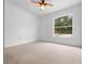 Cozy bedroom featuring neutral carpeting, a ceiling fan, and a bright window for natural light at 2741 Beaver Dr, Deltona, FL 32725