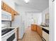 Bright kitchen showcasing wood cabinets, white appliances, and a functional layout at 2741 Beaver Dr, Deltona, FL 32725